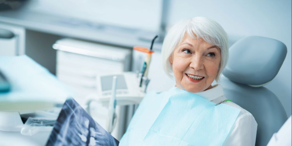 older patient discussing fixed vs removable implant options