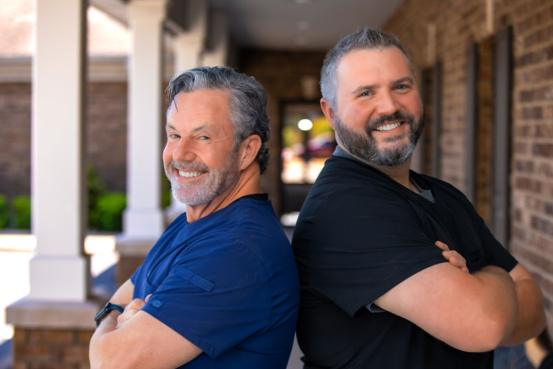 Dr. Britt and Dr. Givens back to back smiling